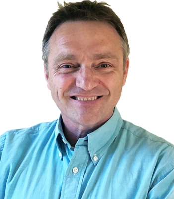 Jean-francois-Roos-organisateur-communautaire Un homme aux cheveux bruns et portant une chemise vert-bleu.
