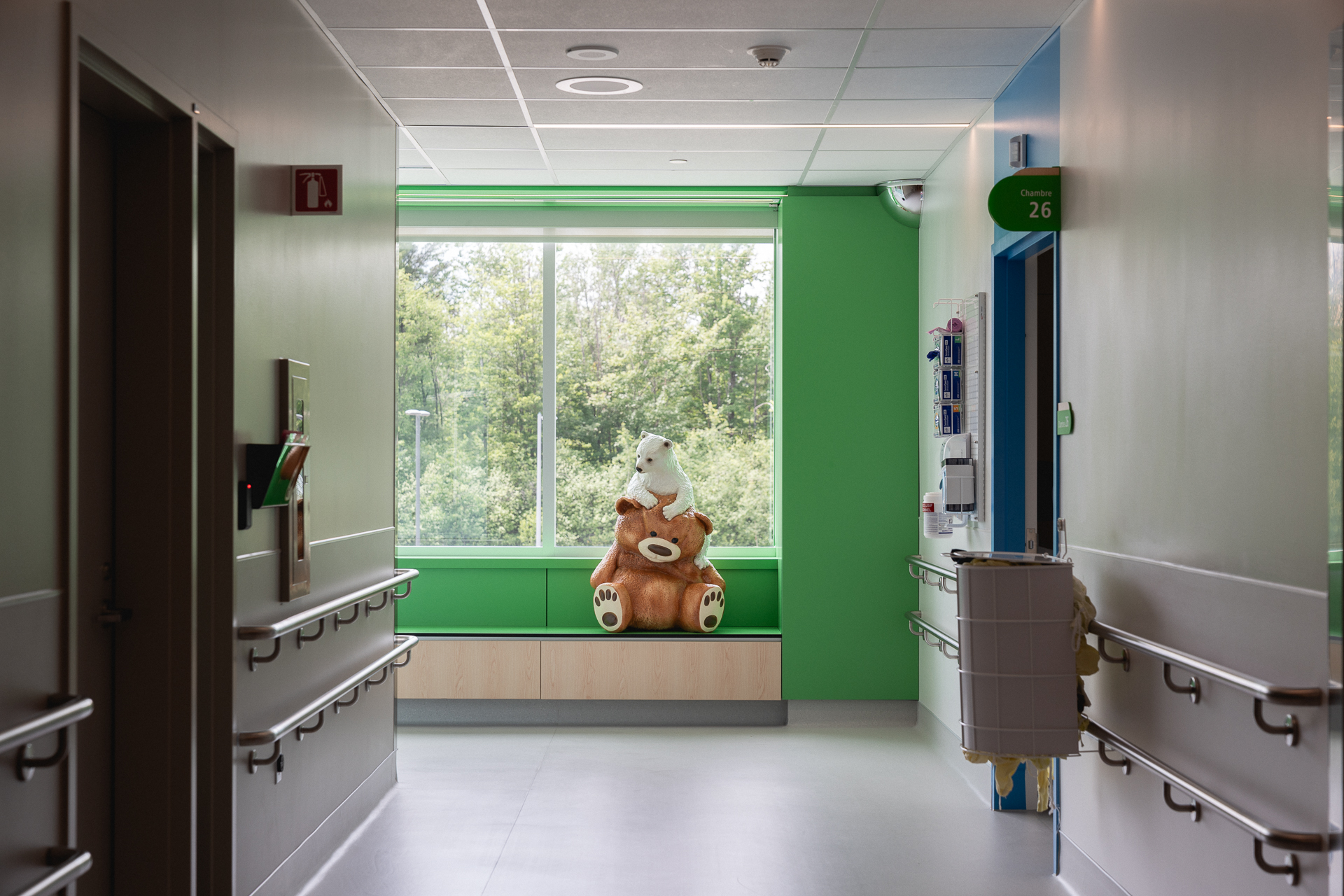 Un ourson polaire blanc grimpe sur un imposant ours en peluche brun.
